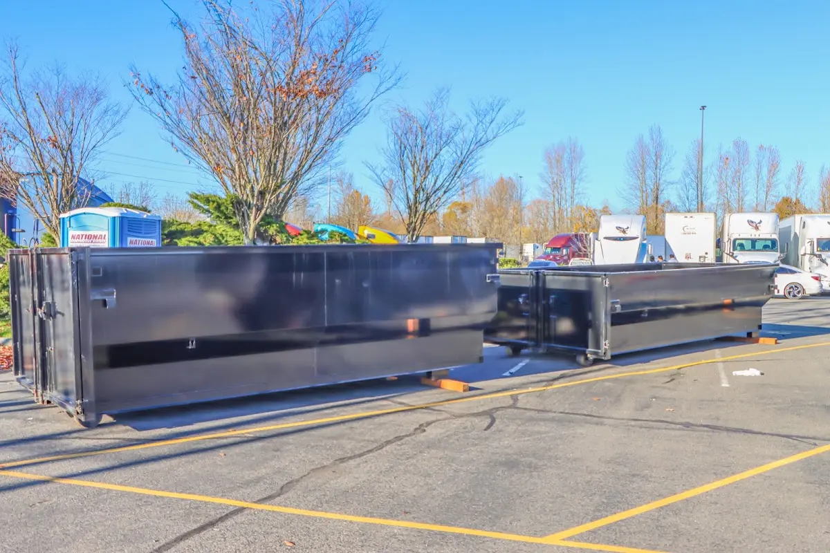 Professional dumpster rental service with roll-off container on residential driveway in St. Anthony